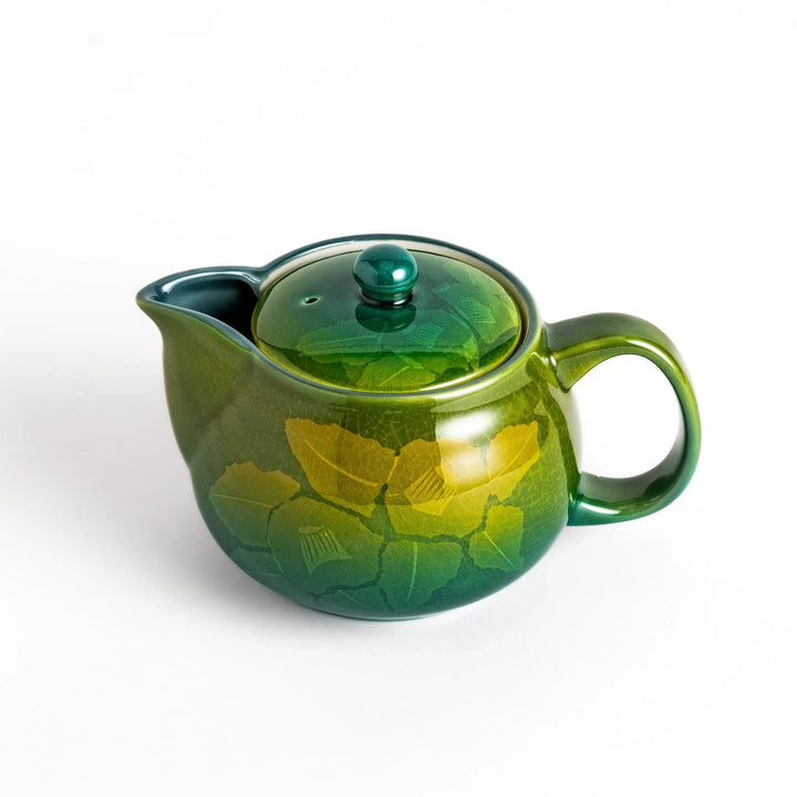 Glossy green ceramic teapot with gradient leaf design and secure lid ideal for everyday tea serving.