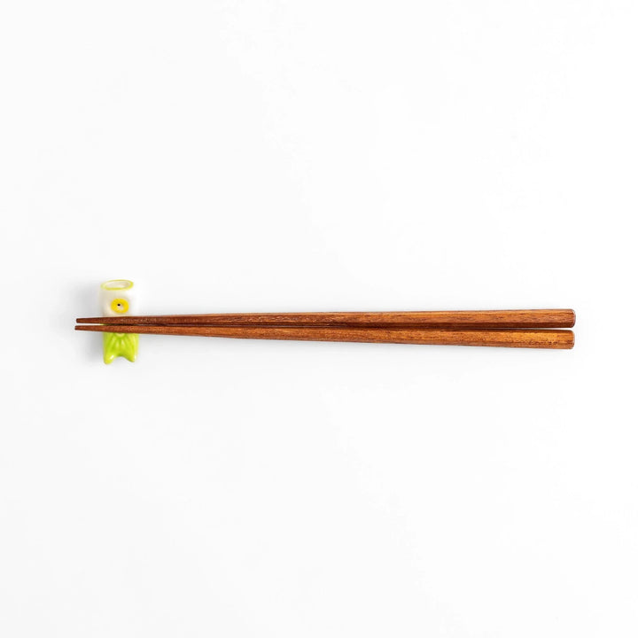 Green carp streamer chopstick rest with a playful yellow eye design.