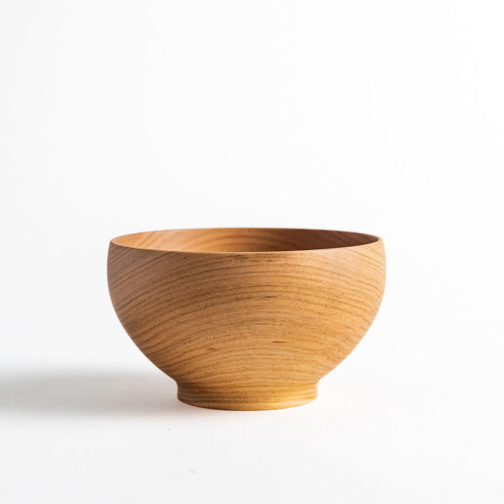 Smooth cherry wood bowl with visible grain and simple elegant design displayed on white background.
