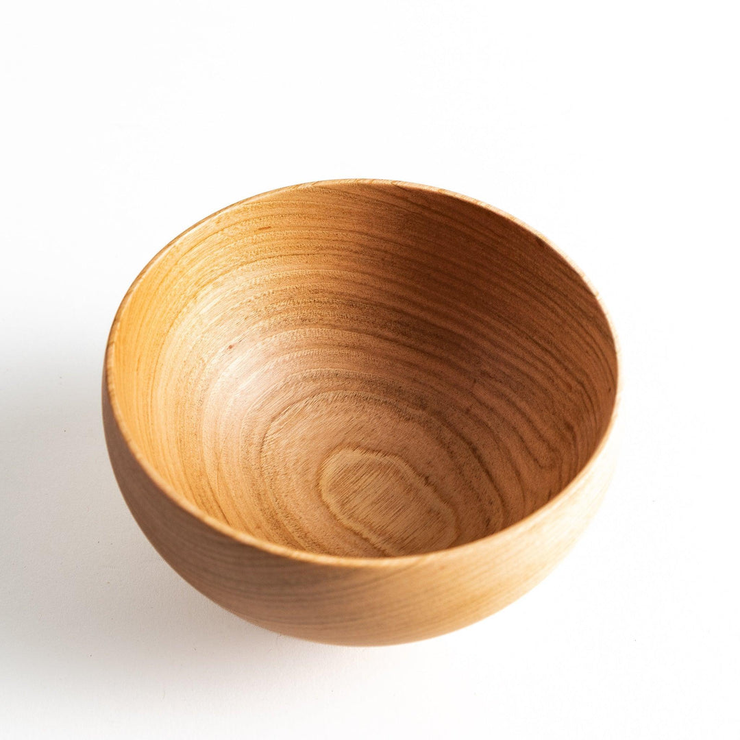 Smooth cherry wood bowl with visible grain and simple elegant design displayed on white background.