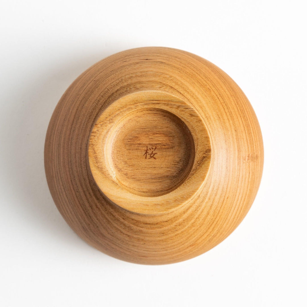 Smooth cherry wood bowl with visible grain and simple elegant design displayed on white background.