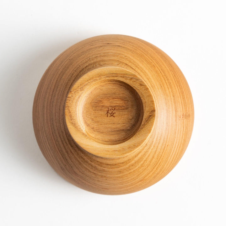 Smooth cherry wood bowl with visible grain and simple elegant design displayed on white background.