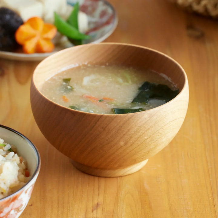 Cherry wood miso soup bowl filled with soup showing warm tone and natural wood grain handcrafted in Japan.