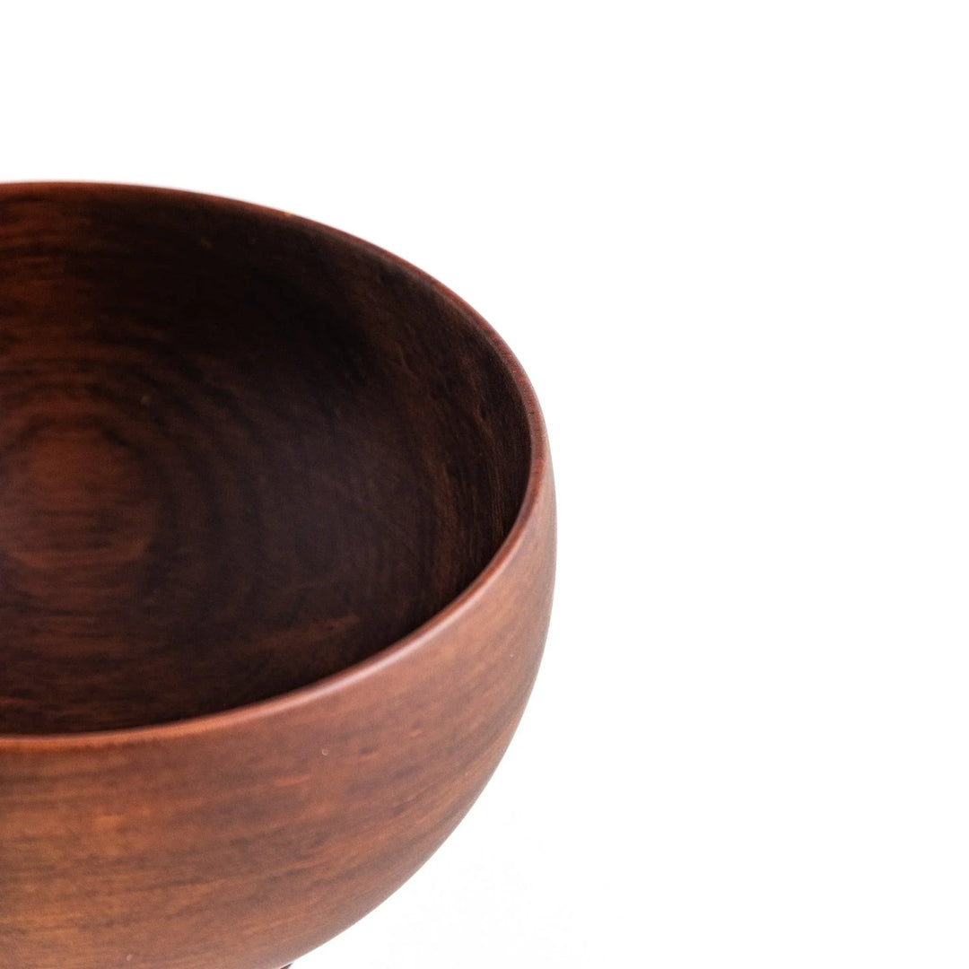 Close-up of the rich brown wooden bowl, highlighting its elegant design and polished finish for stylish dining.
