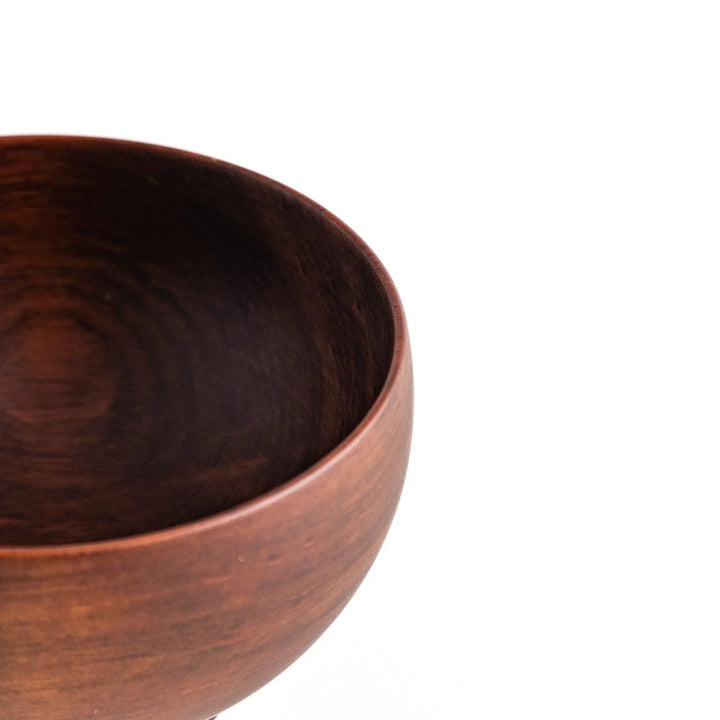 Close-up of the rich brown wooden bowl, highlighting its elegant design and polished finish for stylish dining.