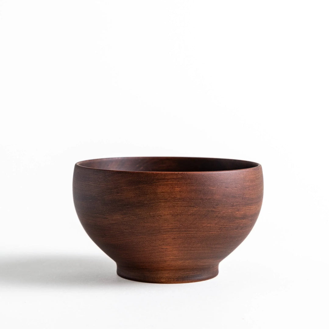 Handcrafted wooden bowl with a rich color and elegant shape, ideal for serving miso soup or salads with style.