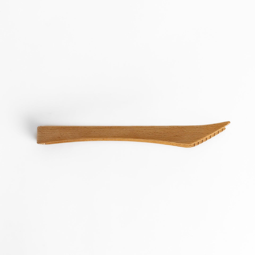 Handcrafted wooden tongs with a smooth surface and angled tips, perfect for stylishly serving or handling food.