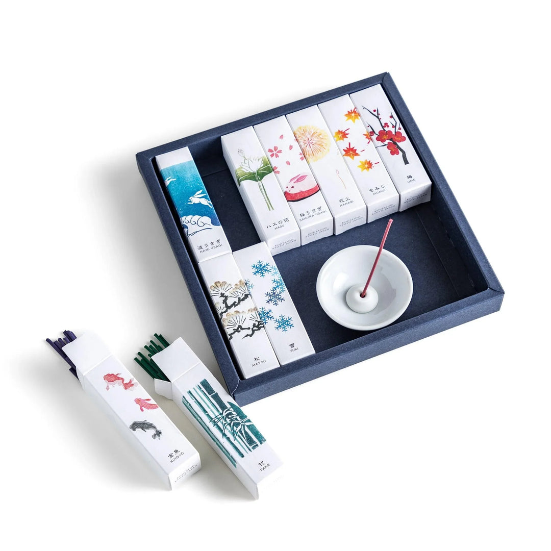 Japanese incense gift set of ten boxes with nature inspired scents and ceramic holder for elegant use.