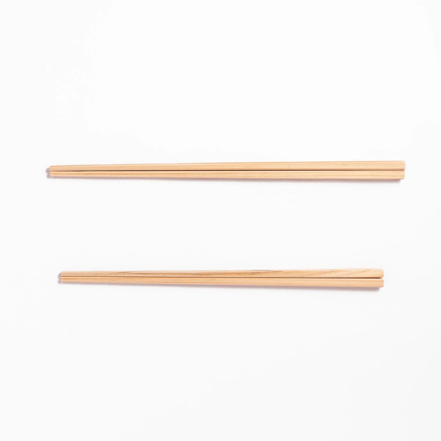 Pair of hinoki wood cooking chopsticks with smooth light wood grain and tapered ends, ideal for Japanese cuisine