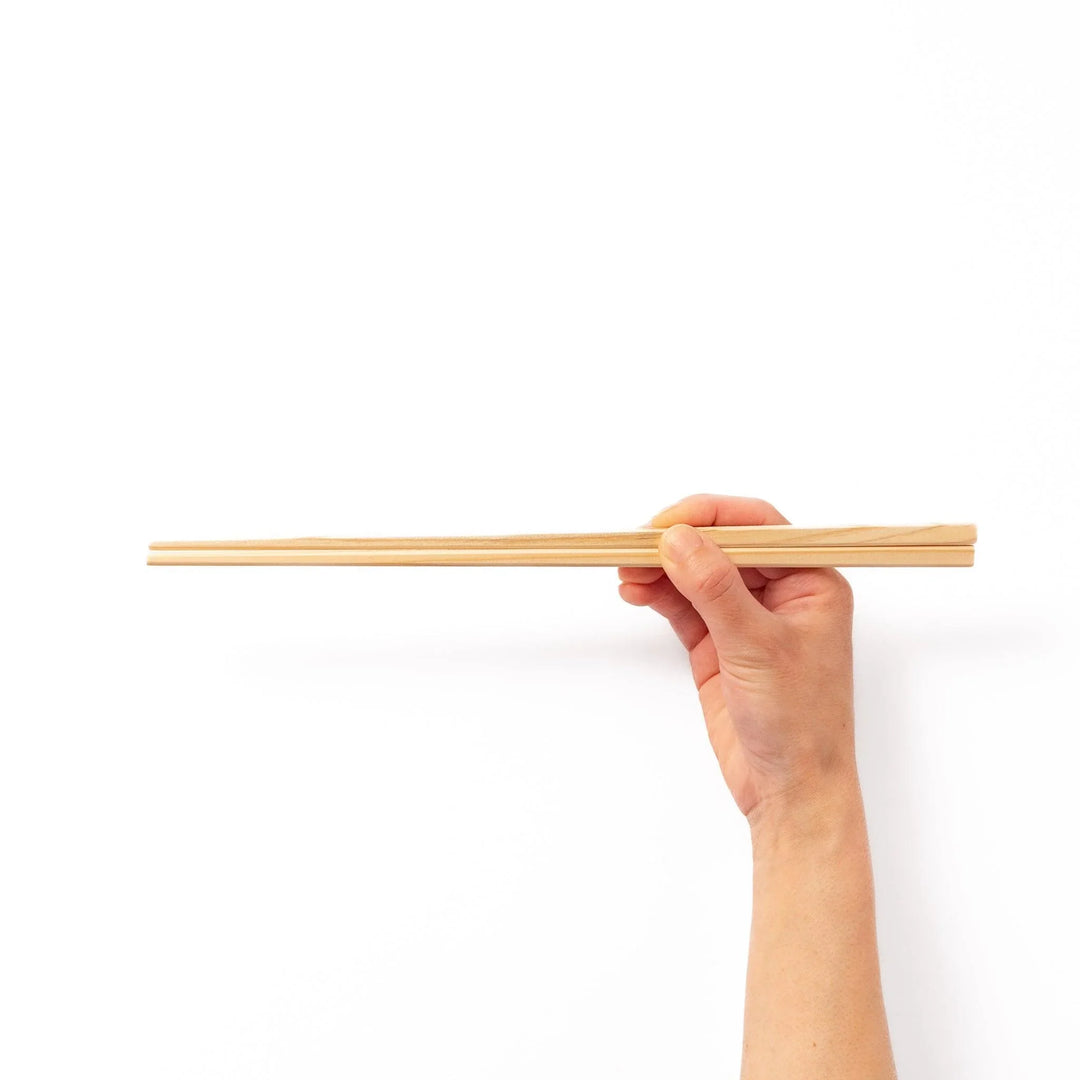 Pair of hinoki wood cooking chopsticks with smooth light wood grain and tapered ends, ideal for Japanese cuisine