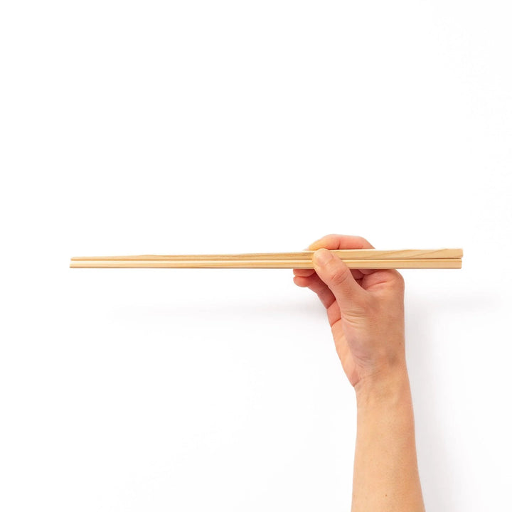 Pair of hinoki wood cooking chopsticks with smooth light wood grain and tapered ends, ideal for Japanese cuisine