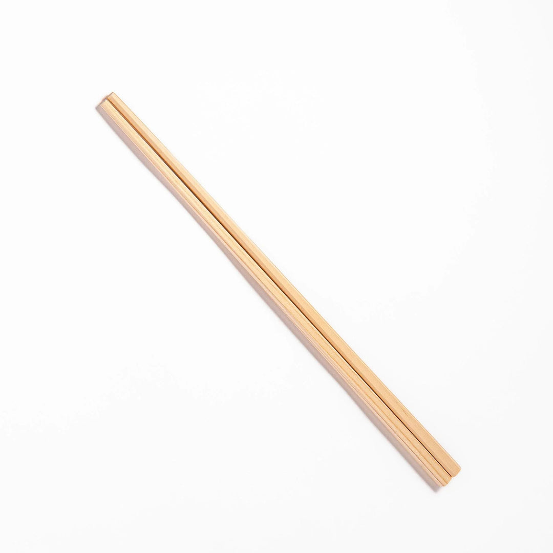Pair of hinoki wood cooking chopsticks with smooth light wood grain and tapered ends, ideal for Japanese cuisine