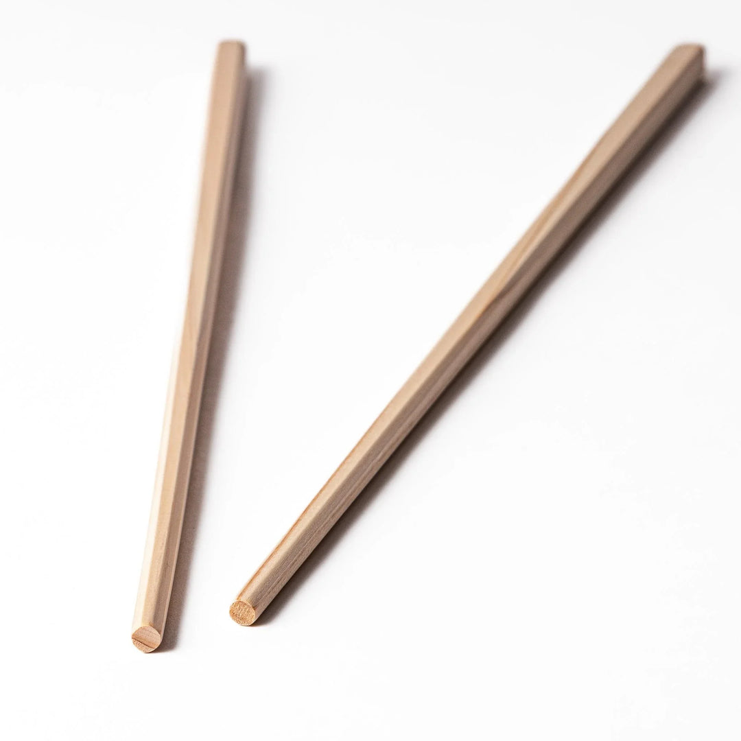 Pair of hinoki wood cooking chopsticks with smooth light wood grain and tapered ends, ideal for Japanese cuisine