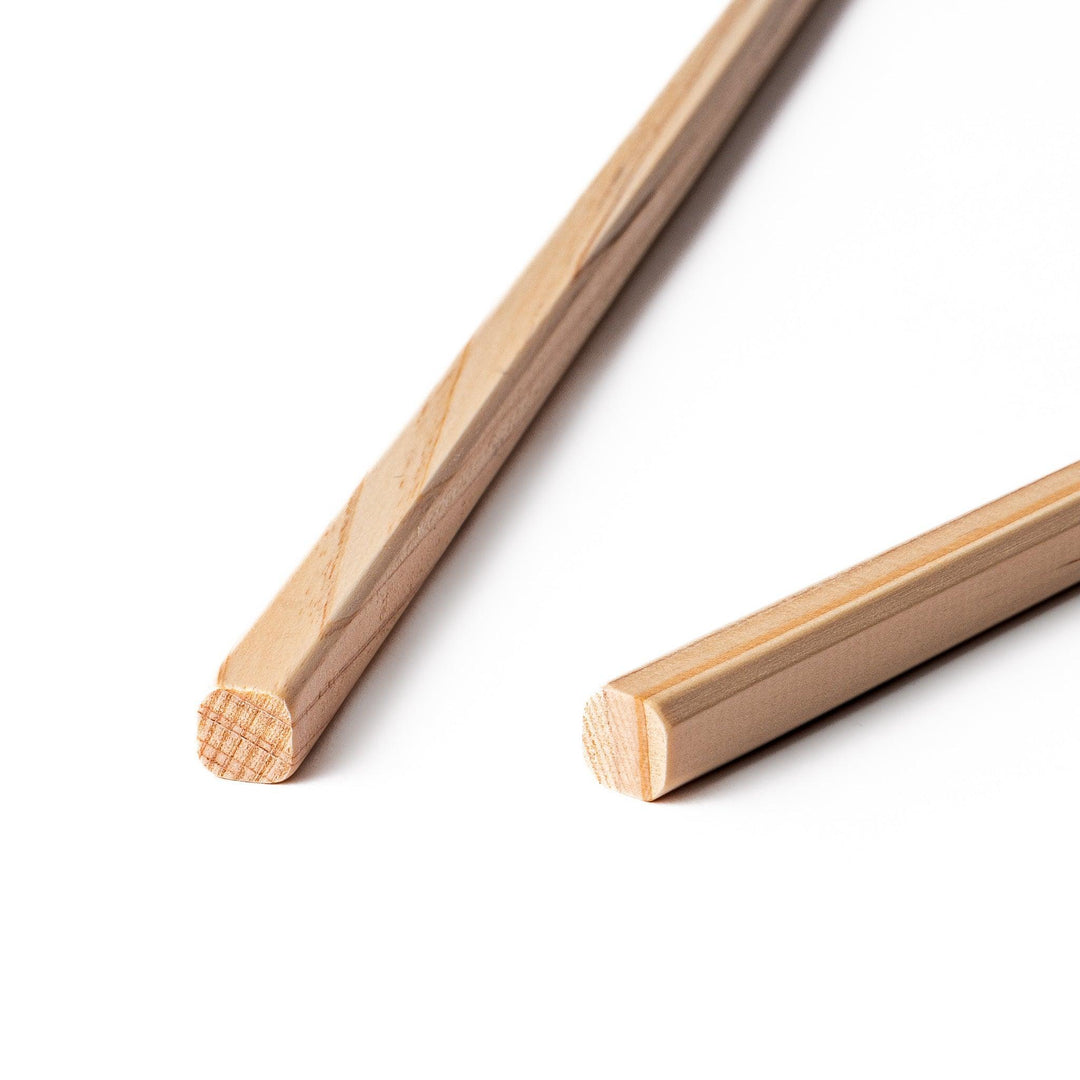 Pair of hinoki wood cooking chopsticks with smooth light wood grain and tapered ends, ideal for Japanese cuisine