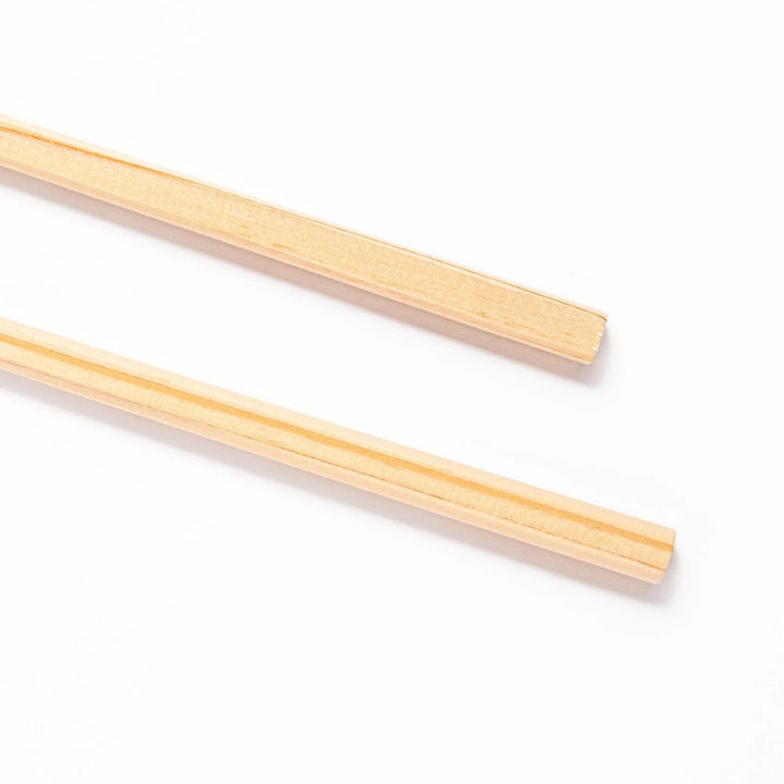 Pair of hinoki wood cooking chopsticks with smooth light wood grain and tapered ends, ideal for Japanese cuisine