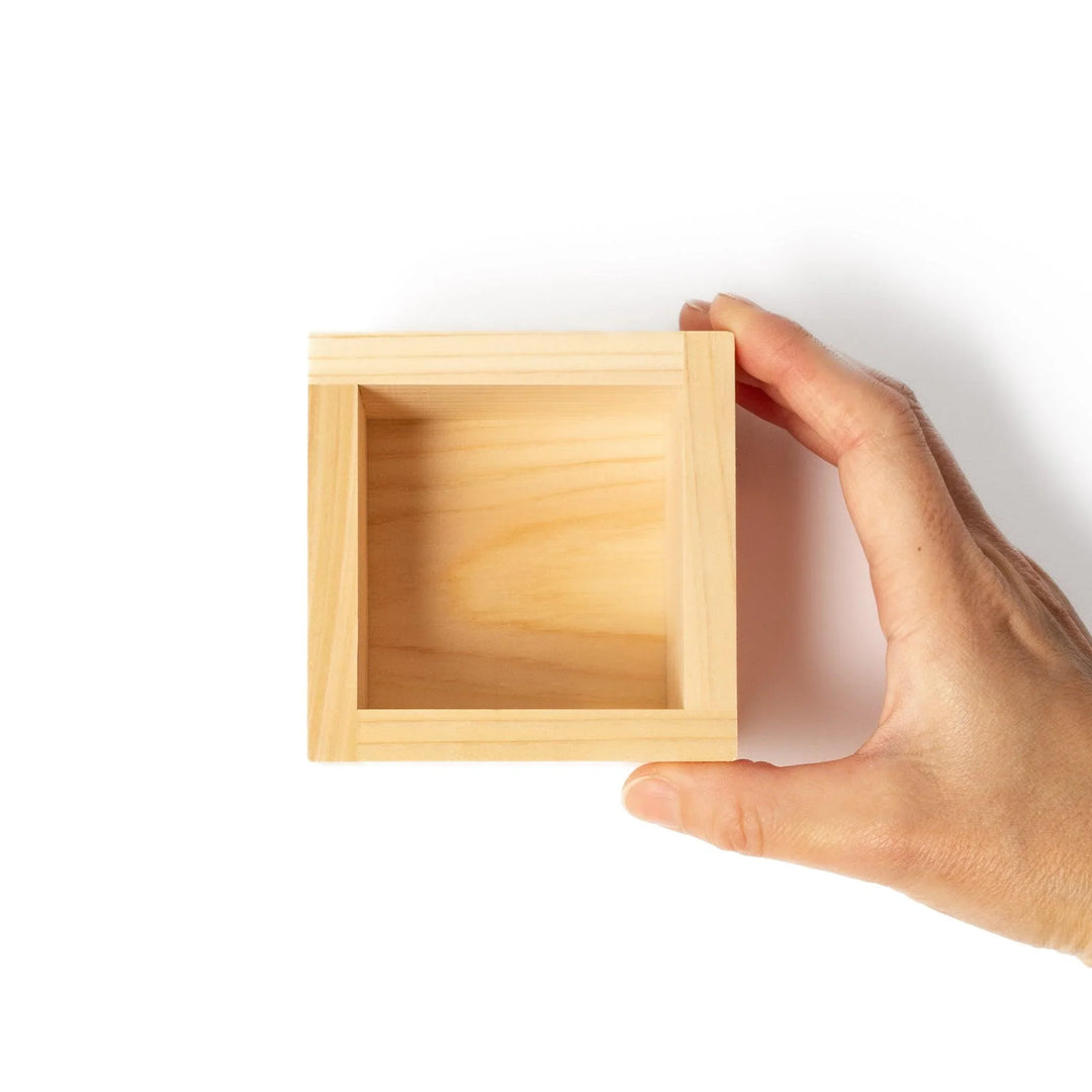 Hinoki wood masu sake cup with visible joinery, offering a natural aroma for sake or condiments.