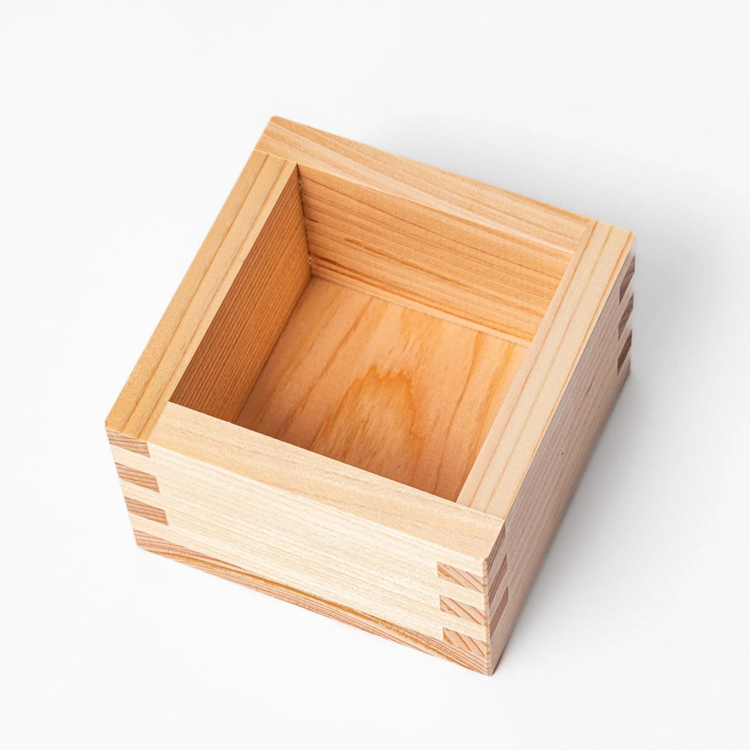 Hinoki wood masu sake cup with visible joinery, offering a natural aroma for sake or condiments.