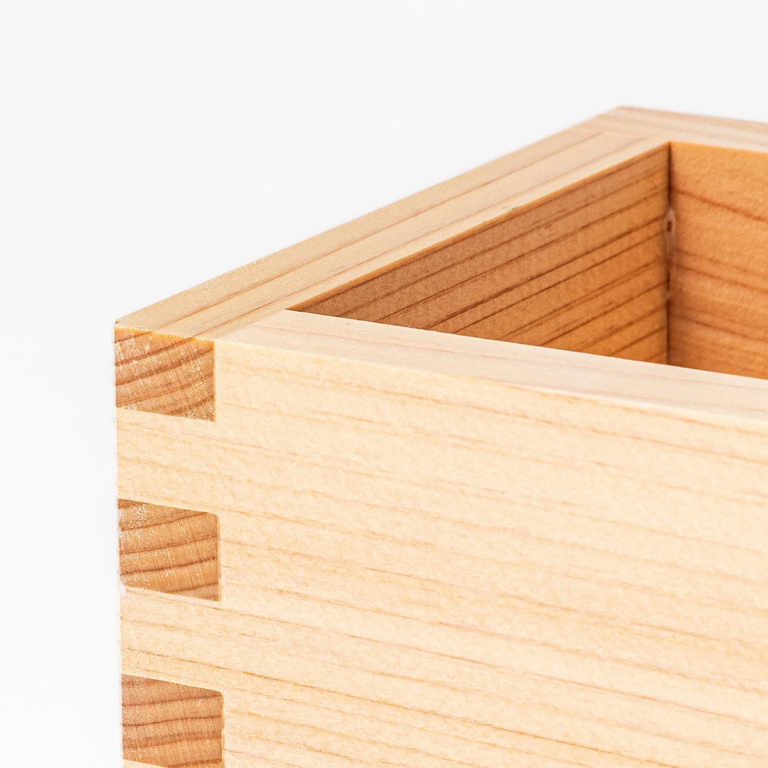 Hinoki wood masu sake cup with visible joinery, offering a natural aroma for sake or condiments.
