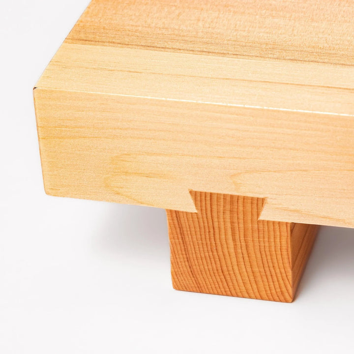 Elevated hinoki wood sushi plate with natural grain and joinery ideal for refined Japanese presentation.