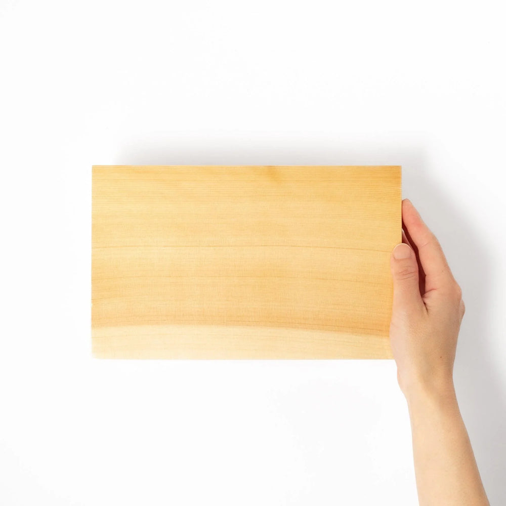 Rectangular hinoki wood sushi plate with raised legs perfect for serving sushi or appetizers elegantly.