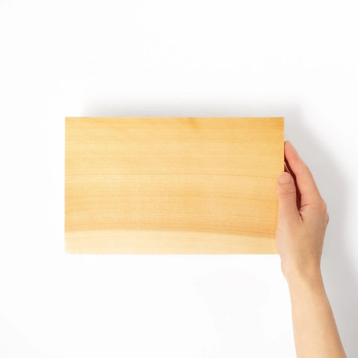 Rectangular hinoki wood sushi plate with raised legs perfect for serving sushi or appetizers elegantly.