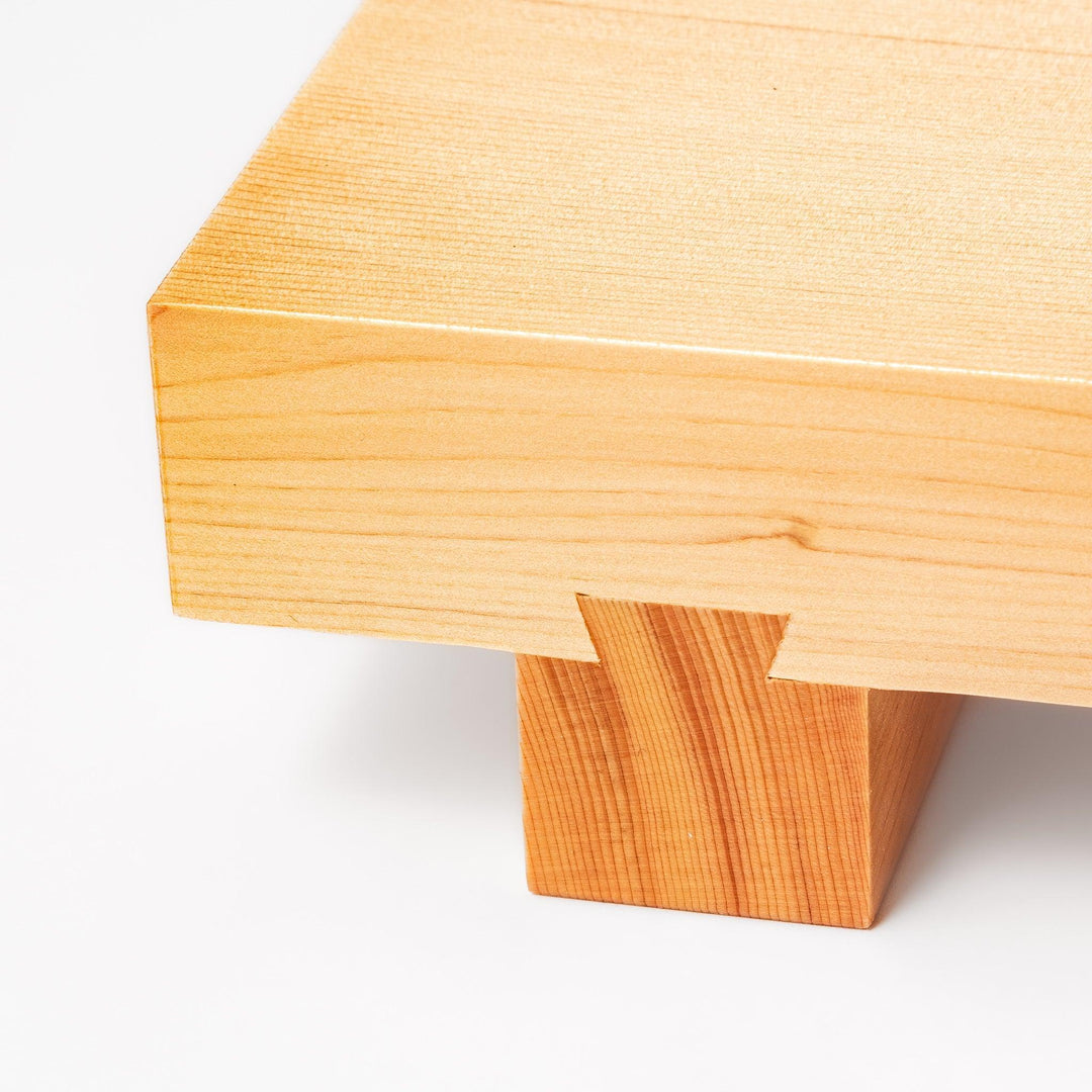 Rectangular hinoki wood sushi plate with raised legs perfect for serving sushi or appetizers elegantly.