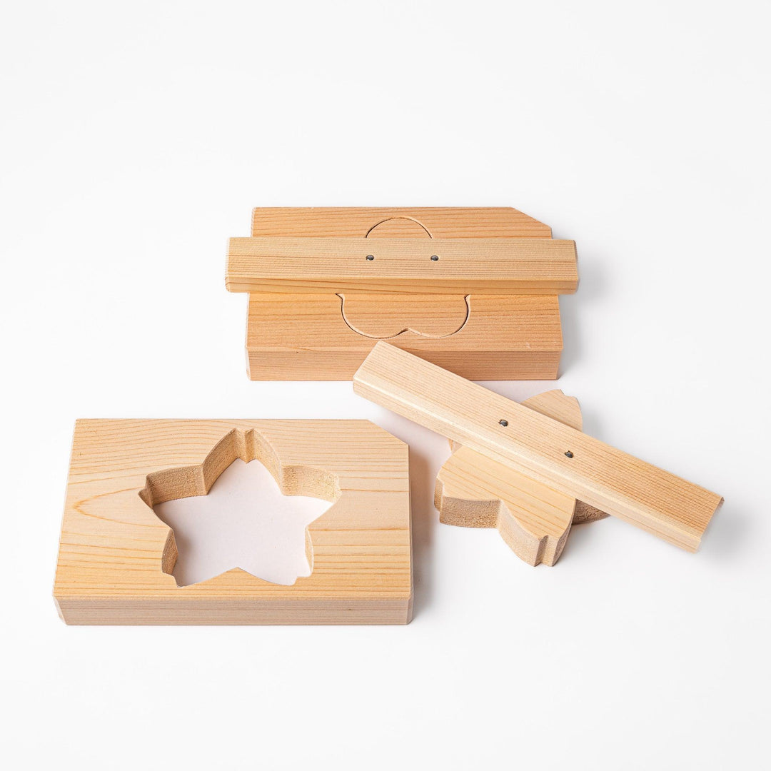 Set of hinoki onigiri molds in plum and sakura shapes, ideal for crafting decorative, fragrant rice balls.