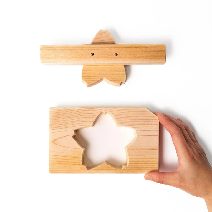 Hinoki onigiri mold in sakura shape, designed to press rice into floral forms with natural aroma.