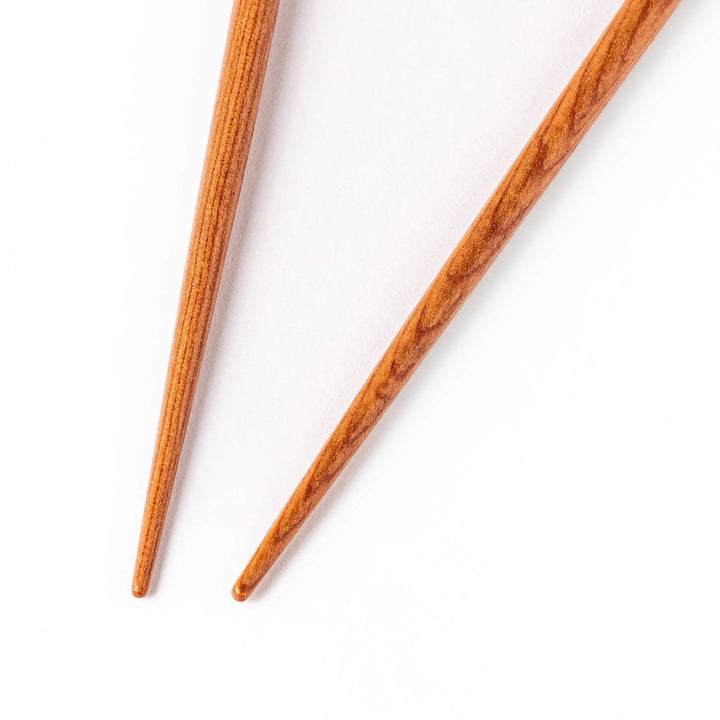 Pair of brown chopsticks with tapered ends, crafted from smooth wood, ideal for sushi and Japanese cuisine