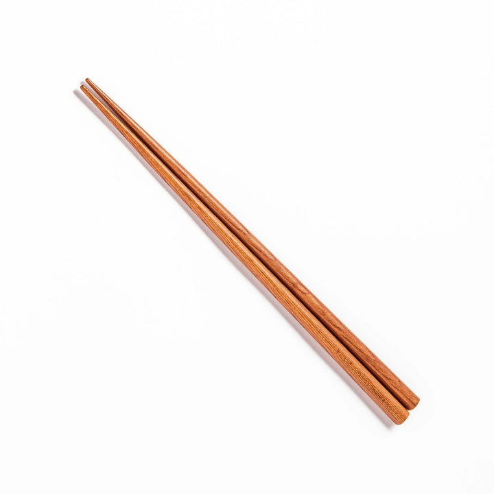 Pair of brown chopsticks with tapered ends, crafted from smooth wood, ideal for sushi and Japanese cuisine