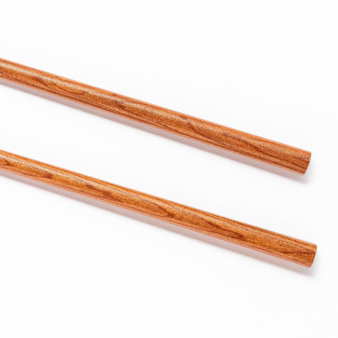 Pair of brown chopsticks with tapered ends, crafted from smooth wood, ideal for sushi and Japanese cuisine