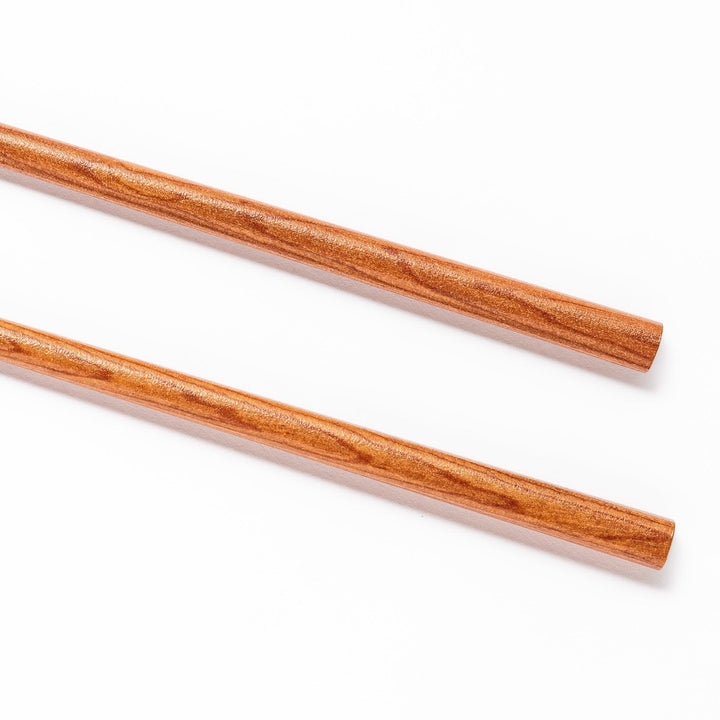 Pair of brown chopsticks with tapered ends, crafted from smooth wood, ideal for sushi and Japanese cuisine