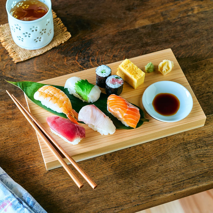 Hinoki wood sushi plate set with nigiri soy sauce dish and chopsticks for elegant Japanese food presentation.