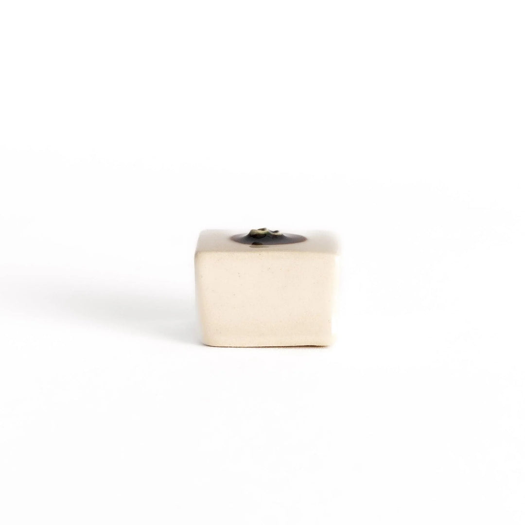 Ceramic tofu chopstick rest shaped like hiyayakko block with beige cube and decorative circular detail.