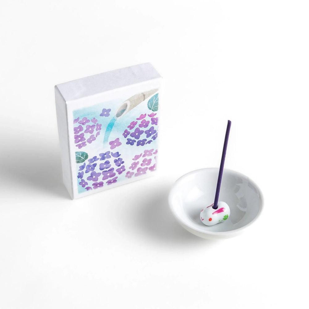 Incense with purple sticks in a hydrangea box, offering a refreshing floral scent for a serene atmosphere.