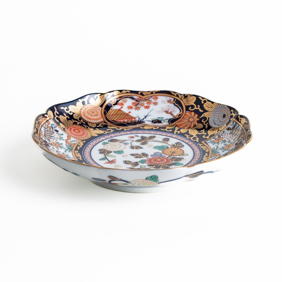 Deep round luncheon plate with dark blue background floral center gold accents and scenic floral border.