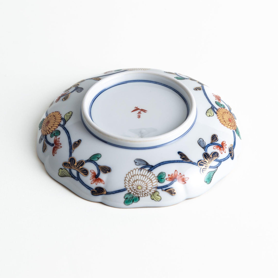 Deep round salad plate with dark blue background floral center and gold red designs of Japanese scenery.