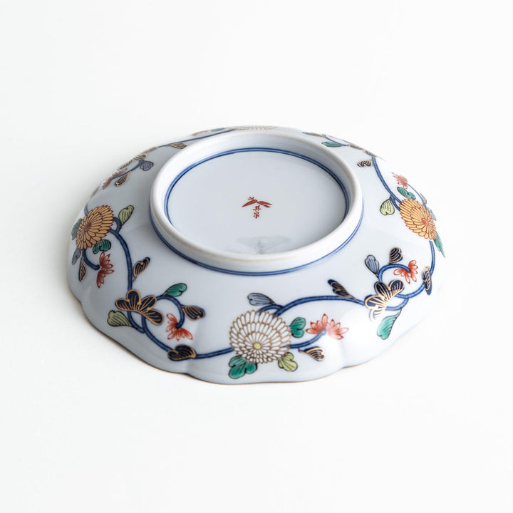 Deep round salad plate with dark blue background floral center and gold red designs of Japanese scenery.