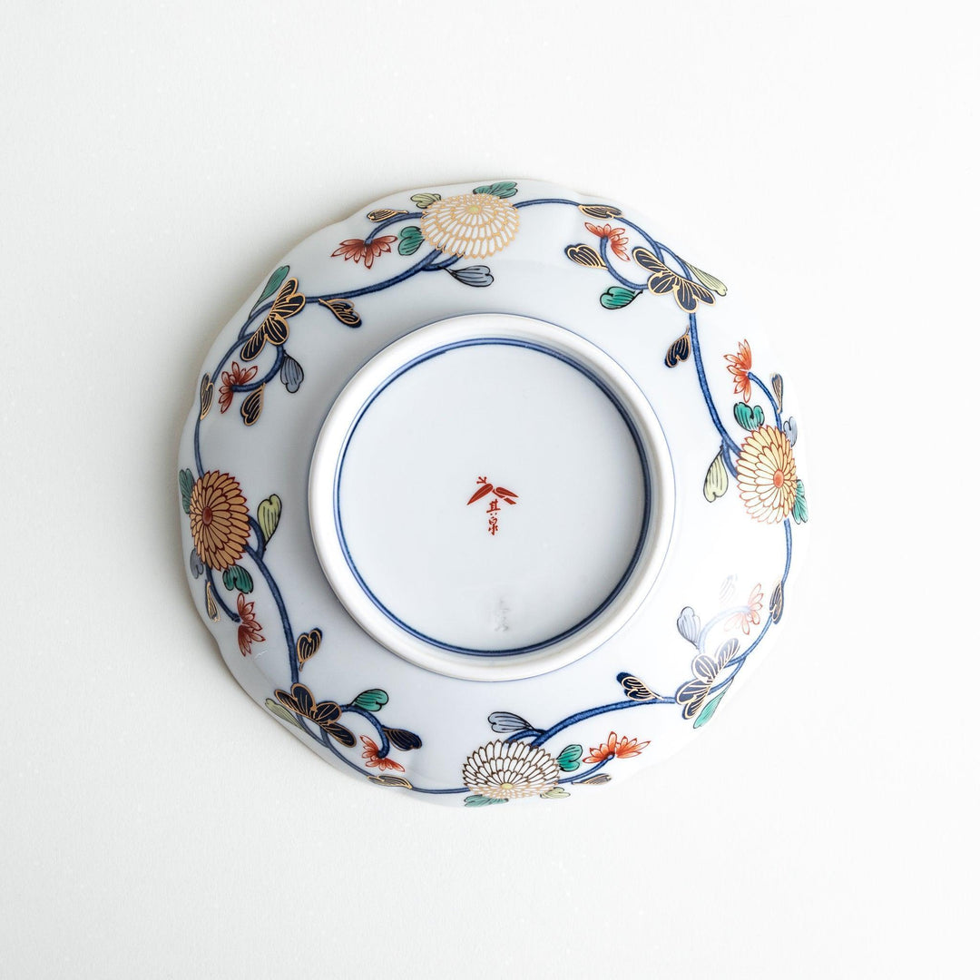 Deep round salad plate with dark blue background floral center and gold red designs of Japanese scenery.