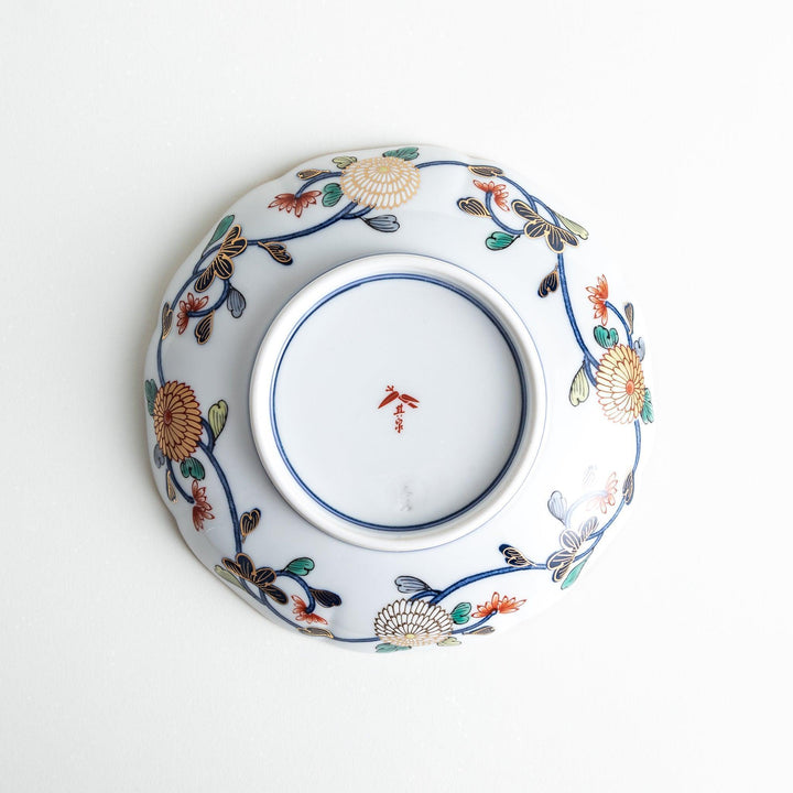 Deep round salad plate with dark blue background floral center and gold red designs of Japanese scenery.