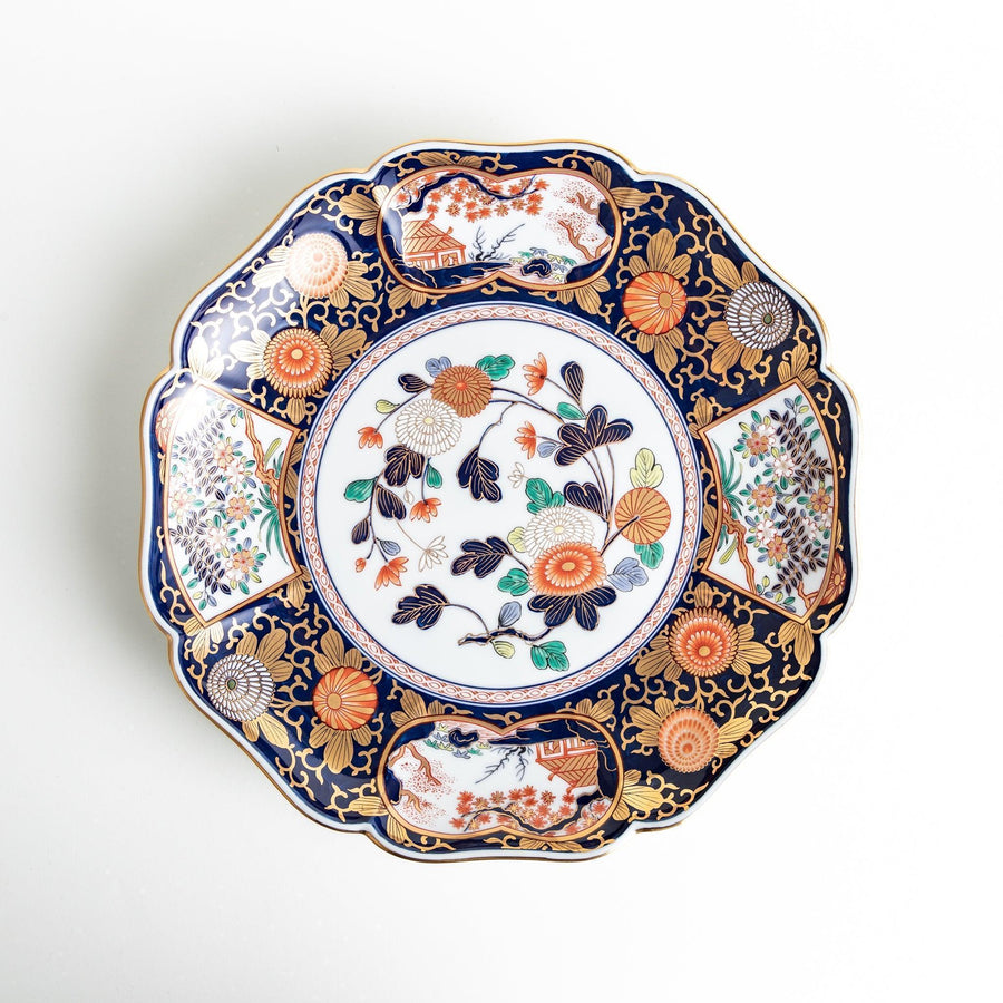 Japanese porcelain serving plate with chrysanthemum and peony motifs in vivid colors and gold detailing on a deep navy base