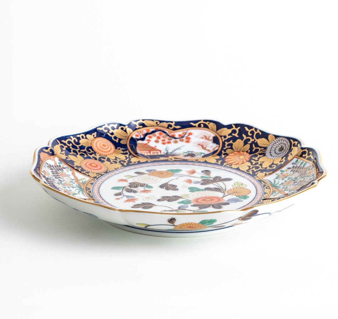 Japanese porcelain serving plate with chrysanthemum and peony motifs in vivid colors and gold detailing on a deep navy base