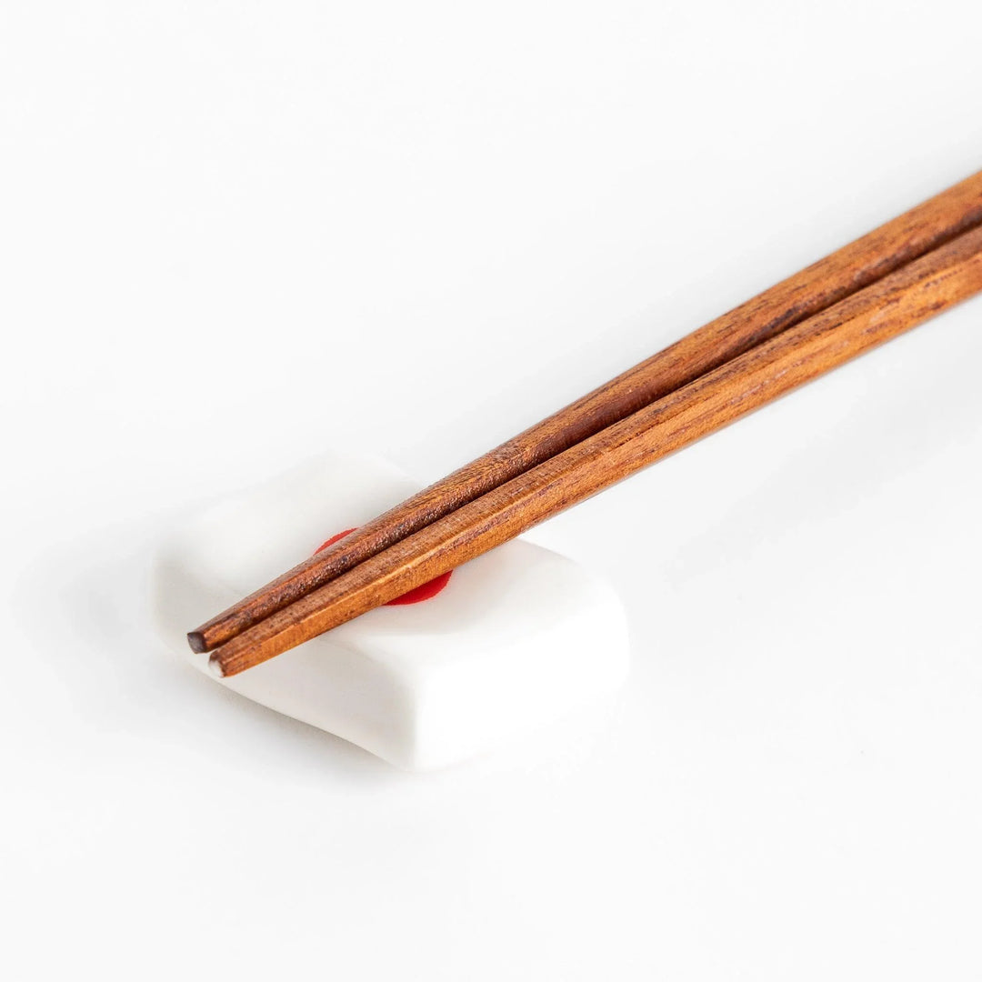 Chopstick rest shaped like the Japanese flag, with a red circle in the center, offering a minimalist and patriotic design.