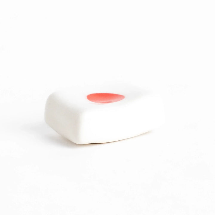 Chopstick rest shaped like the Japanese flag, with a red circle in the center, offering a minimalist and patriotic design.