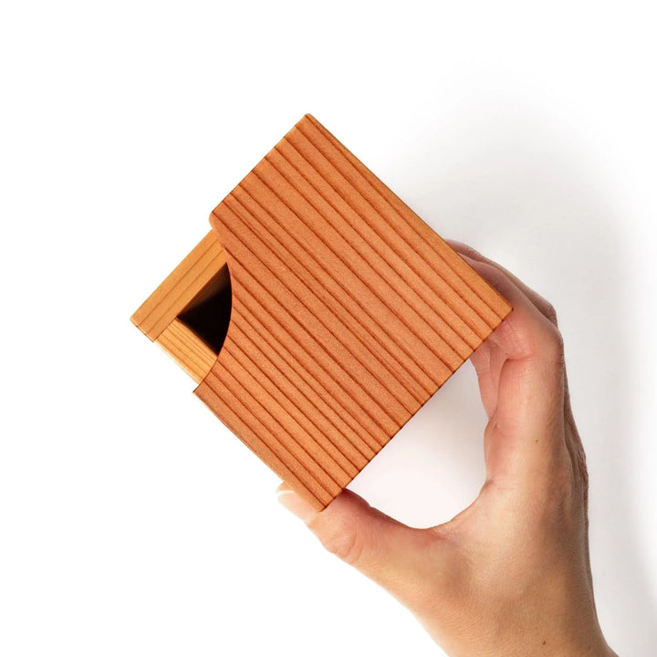 Cedar sake cup with smooth rim and visible grain, offering a warm, aromatic touch to traditional drinkware.