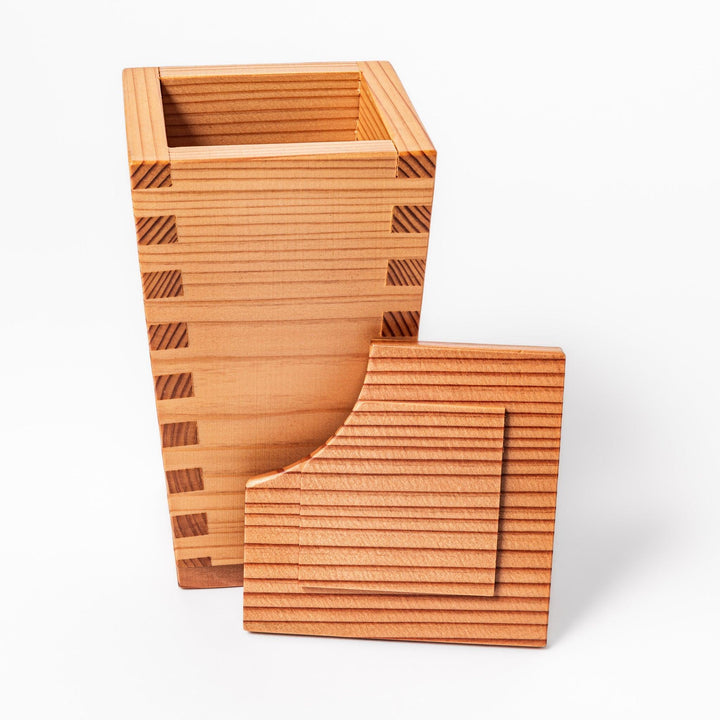 Cedar sake cup with smooth rim and visible grain, offering a warm, aromatic touch to traditional drinkware.