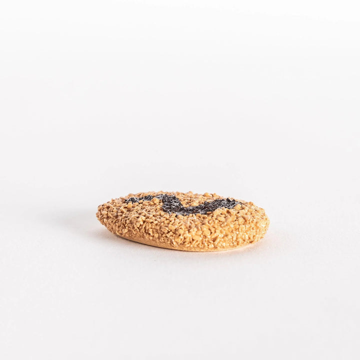 Japanese croquette shaped ceramic chopstick rest with golden brown finish adding fun dining accent.