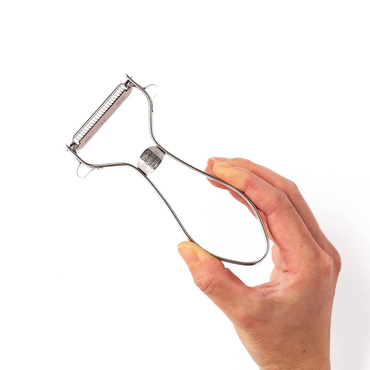 Japanese daikon julienne peeler with stainless steel blade and ergonomic looped handle for thin vegetable strips