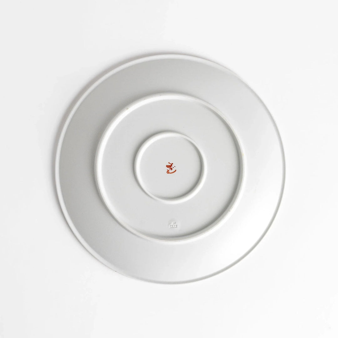 White dinner plate with vibrant temari ball designs, showcasing intricate details.