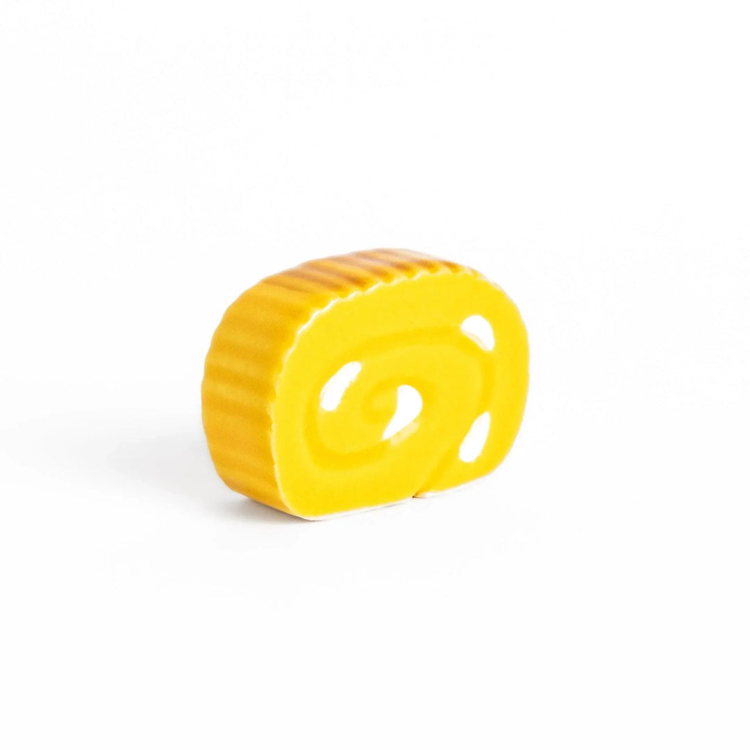 Japanese rolled omelette chopstick rest with bright yellow color adding fun and authentic dining accent.